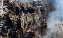 September 17, 2001<br><strong>The ruins of the World Trade Center</strong> <br>In truth, almost no one loved the twin towers as they loved the Empire State and Chrysler Buildings, the great Art Deco skyscrapers that exemplify New York's special brand of arrogance and exuberance. But the towers were undeniably landmarks in the most basic sense of that overused but under-considered word They marked the land. Those shiny square boxes with the slice of sky in between them ultimately worked as massive minimalist sculptures neither beautiful nor stirring, but fixed points on the map that were impossible to ignore. By sheer virtue of their enormous size and scale, they lent coherence to the chaos of modern life. So it seems all the more jarring that they should succumb to that very chaos. <br><i>U.S. Navy photo by Chief Photographer’s Mate Eric J. Tilford</i>