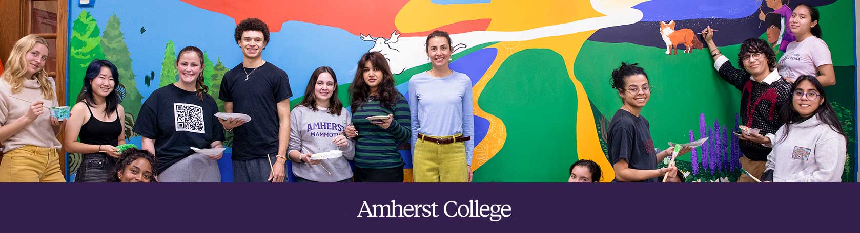 Students stand in front of a sustaonability-themed mural they painted in the fall 2024 semester.