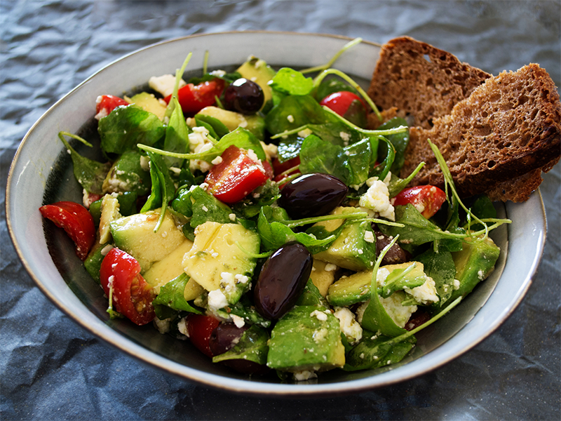 fresh green salad with avocados and whole grain bread