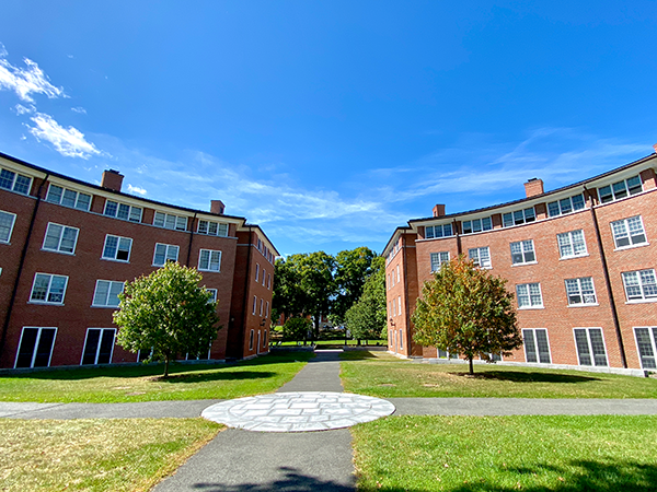 Two Amherst College dorms on a bright afternoon