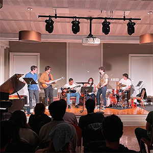 A jazz band playing on a brighly lit stage