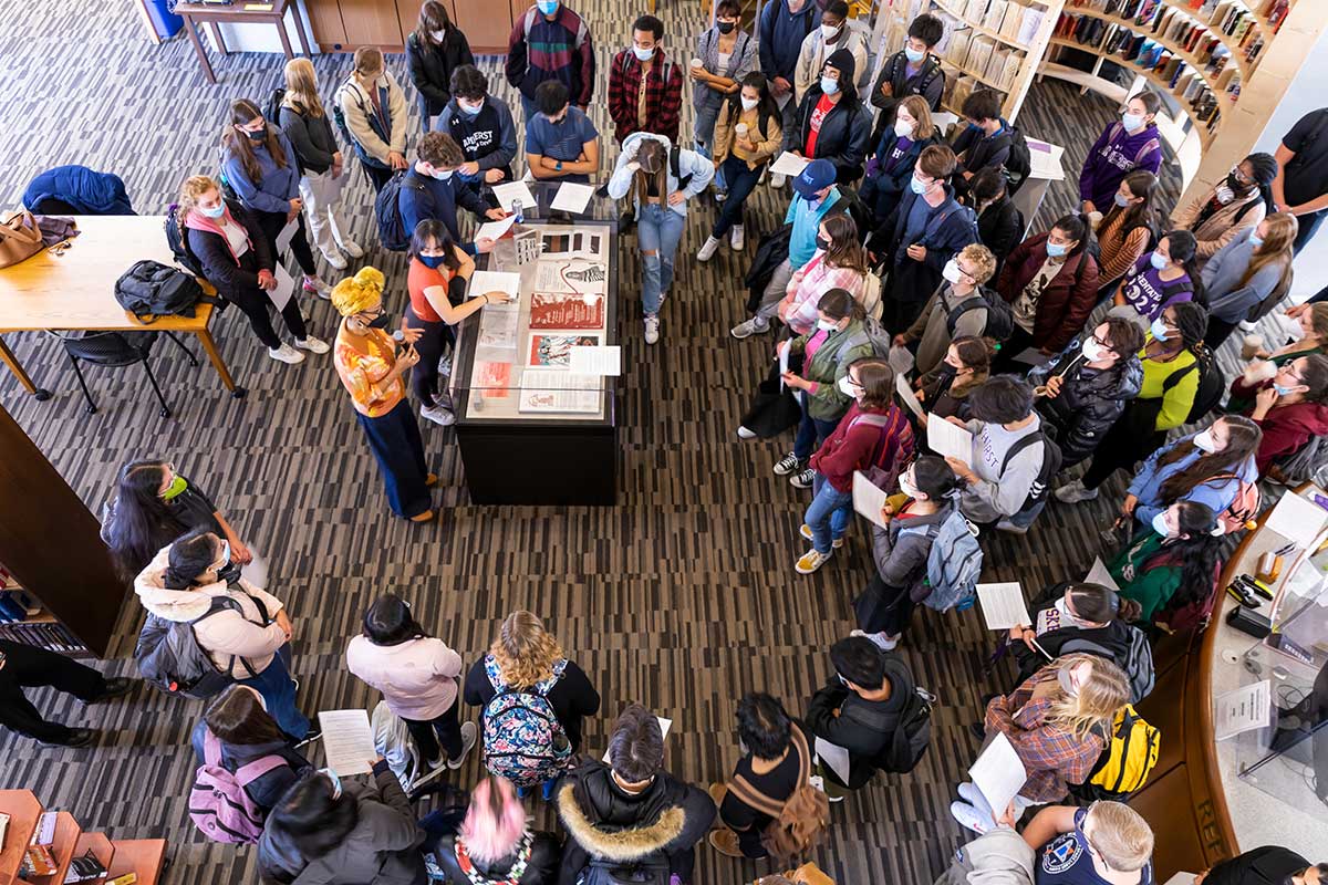 A crowd gathers around Sonya Clark in the Frost Library, reading aloud statements that define solidarity