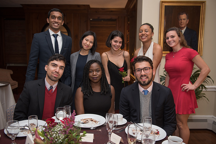 students posing for a photo after an elegant dinner