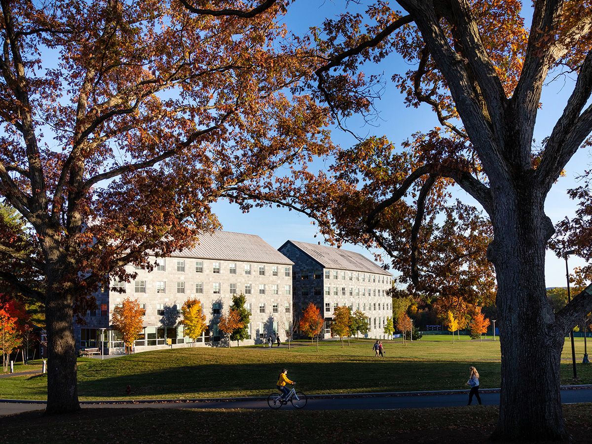 Two stone residence Halls against an autumn backdrop