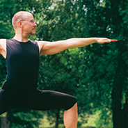 A man posing in a yoga position outdoors