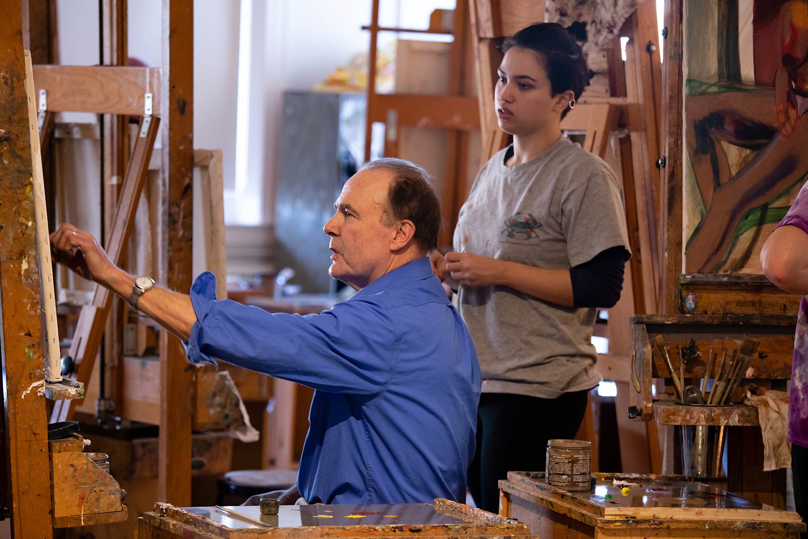 Professor Robert Sweeney working with a student in his Painting 1 course 