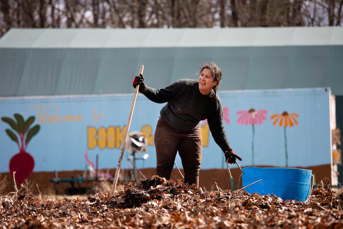 Maida Ives, manager of farm education and operations at the Book & Plow Farm, standing in front of a shipping container