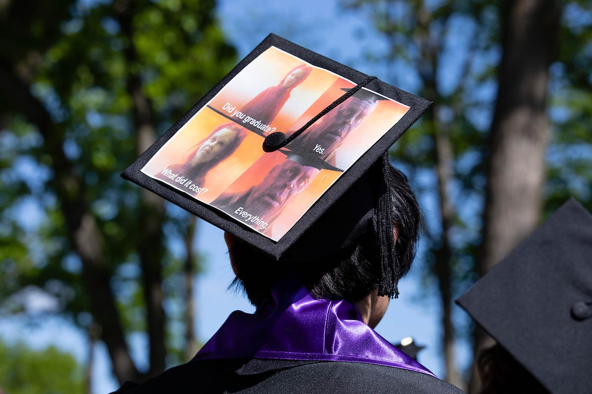 A student with a decorated mortar board at Amherst College's 198th Commencement