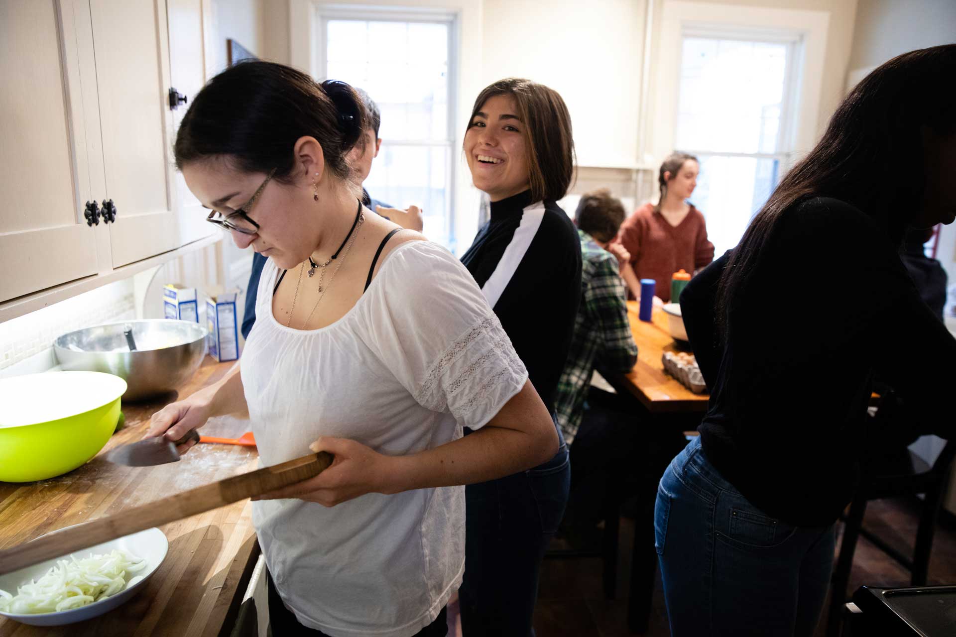 Students cooking in their professor's kitchen