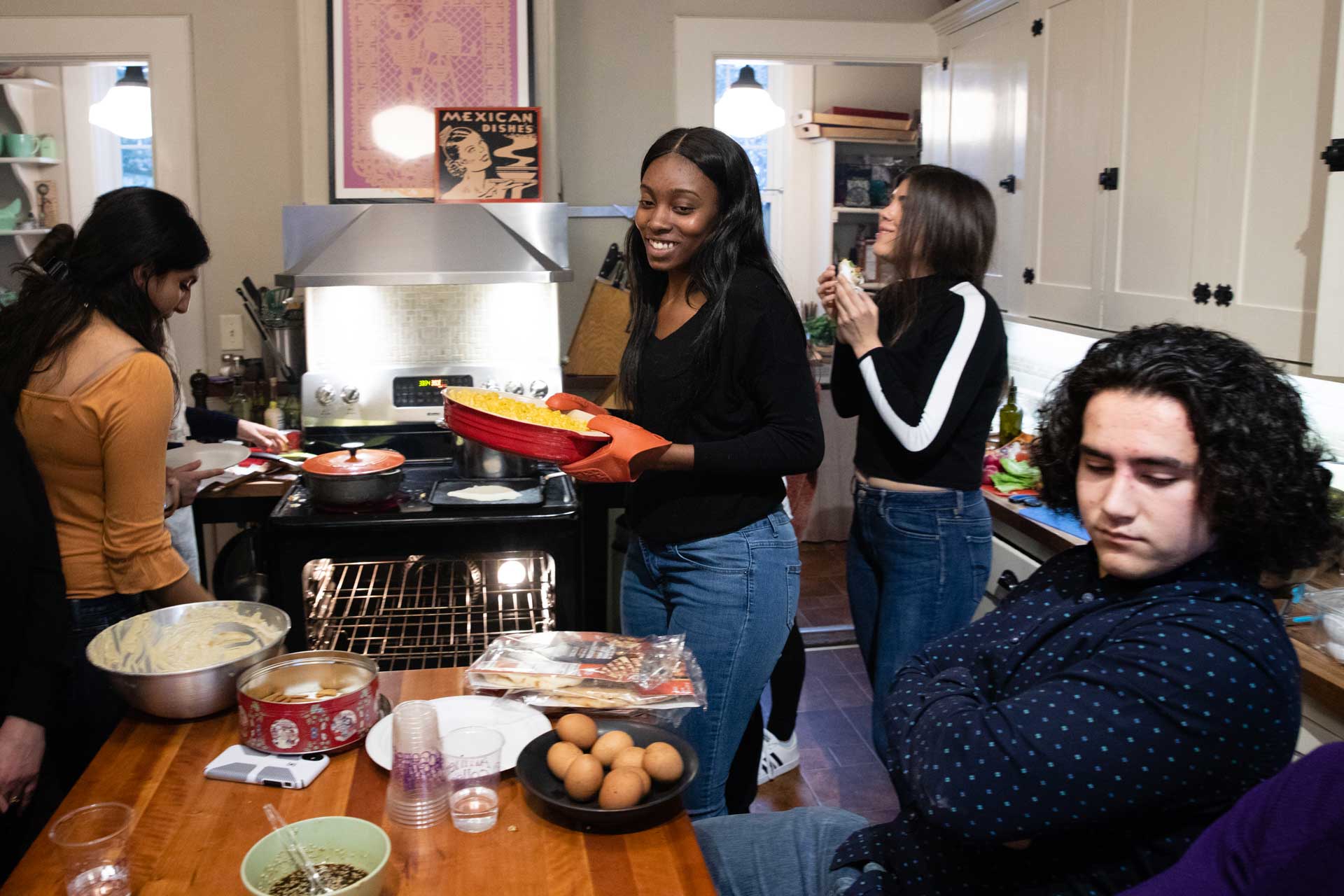 A group of college students gathered around a table