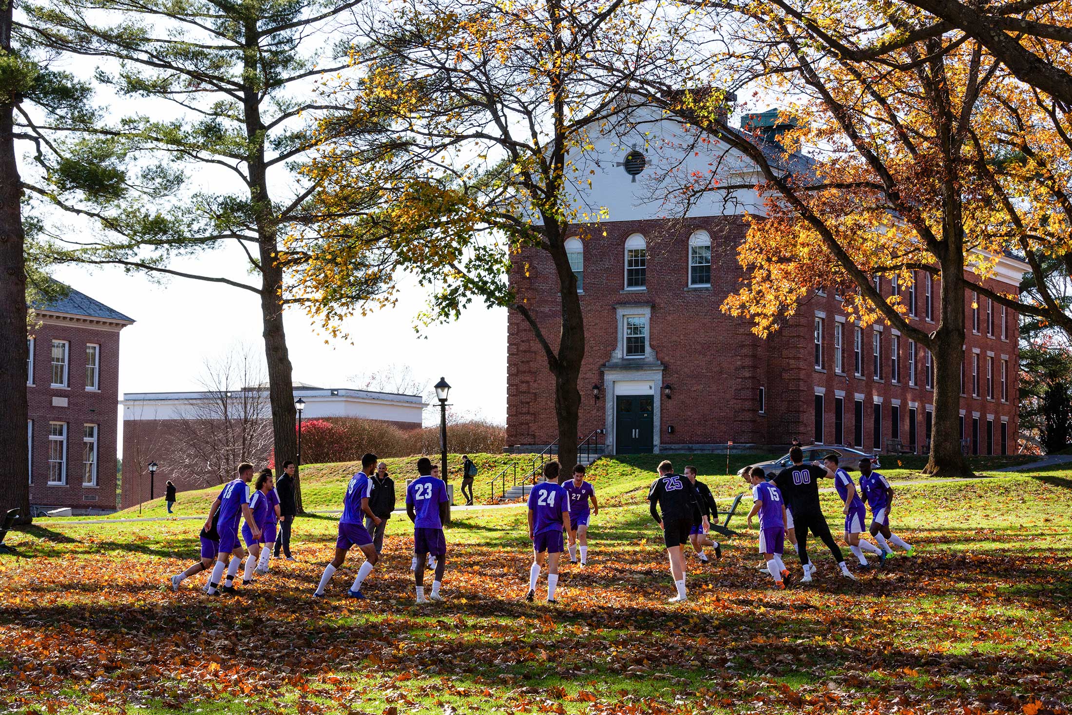 The men's soccer team practicing on the Quad
