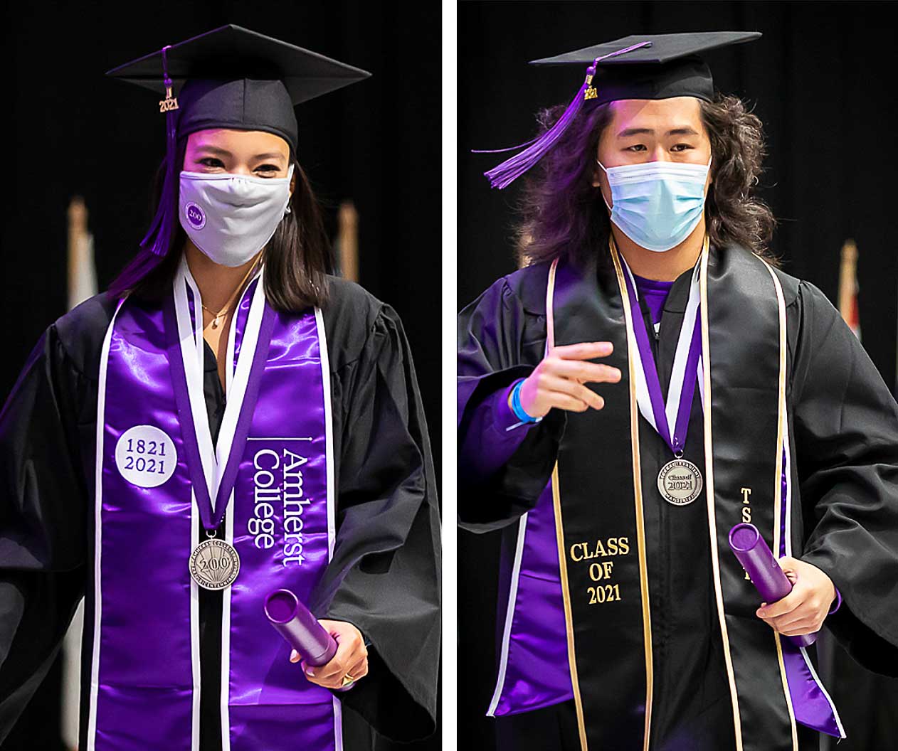 Two graduates exiting the stage after getting their diplomas