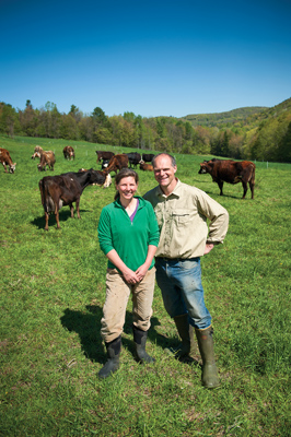 Amy Klippenstein ’89 and Paul Lacinski ’89 with cows on Sidehill Farm