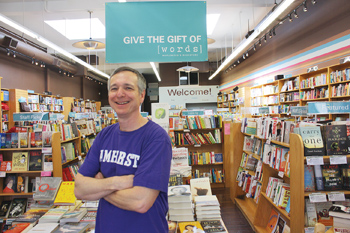 Jonah Zimiles '79 in his bookstore, wearing an Amherst T-shirt