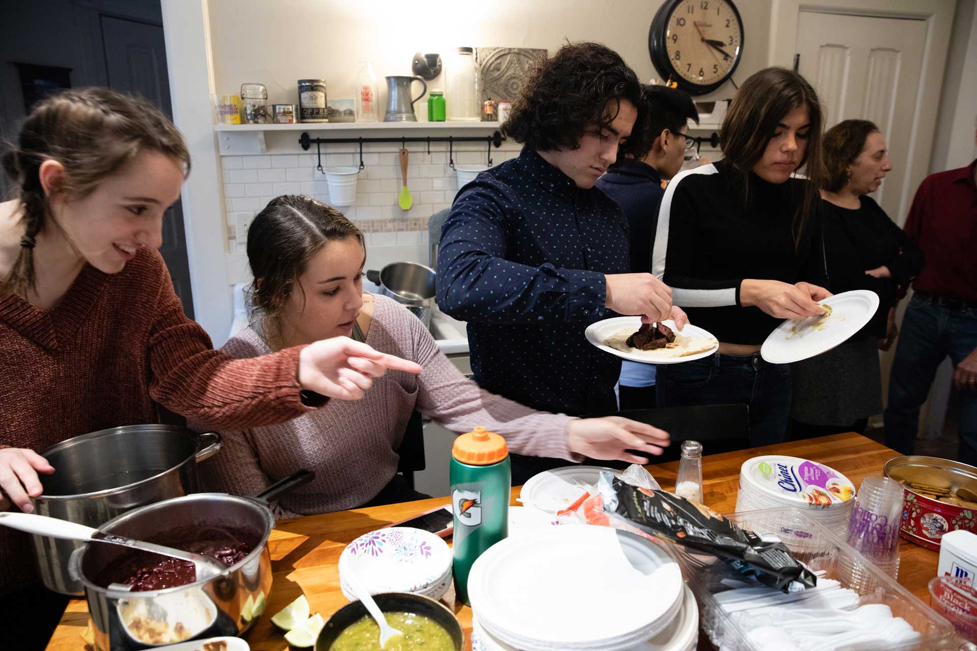 College students eating together in a kitchen