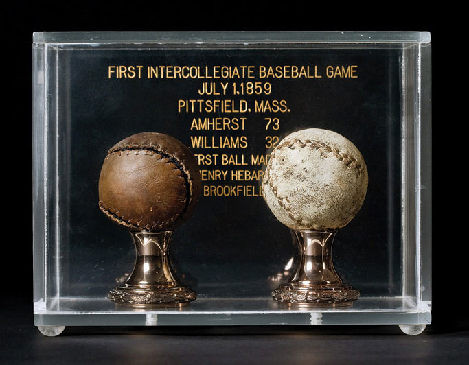 Two old baseballs in a glass case