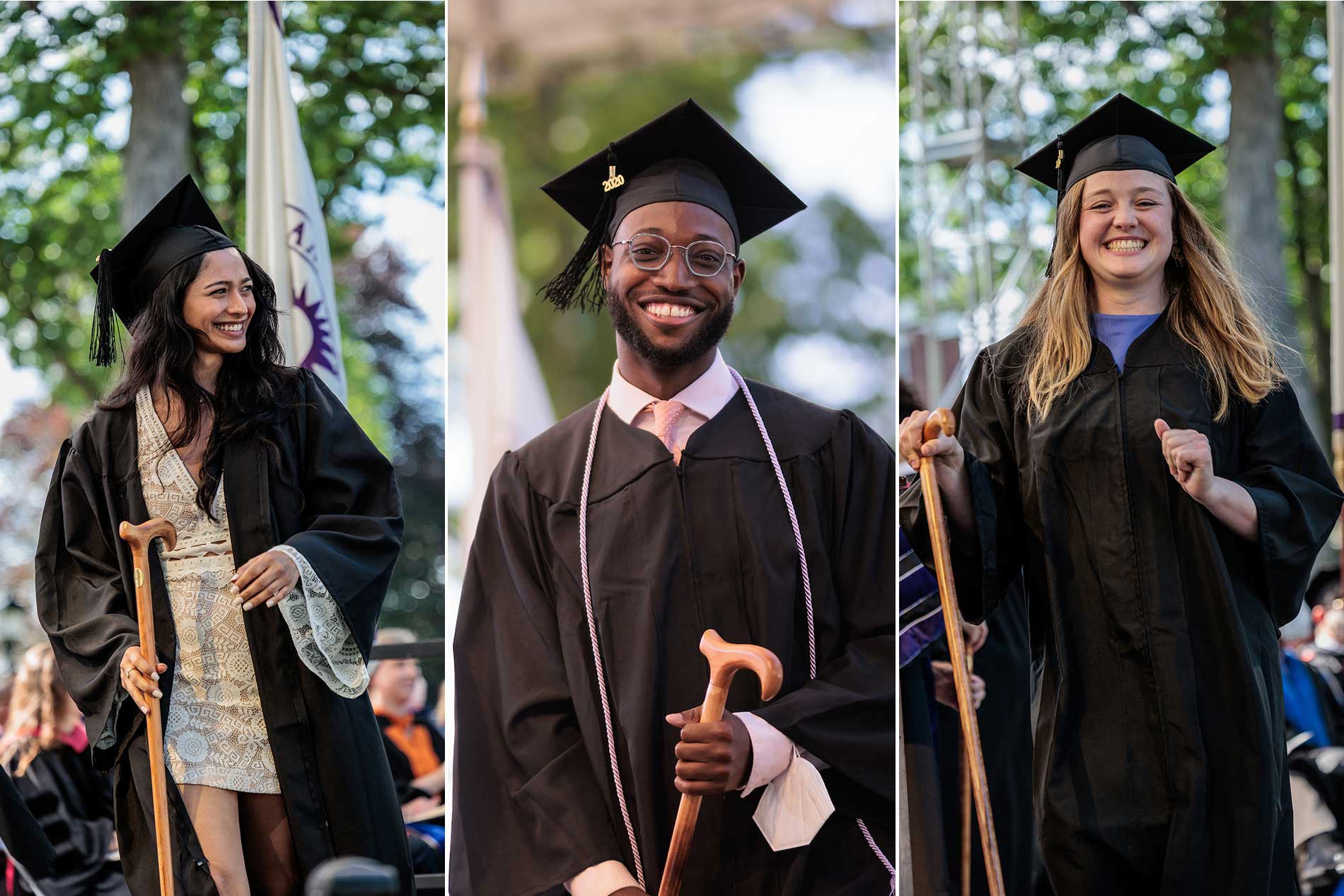 Three students smile after receiving their diplomas.
