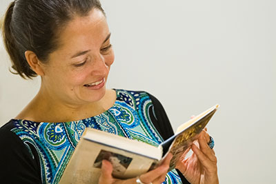 Kiara Visil holding a book from the  Kim-Wait/Eisenberg Native American Literature Collection