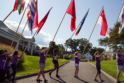 Students carrying flags at Orientation