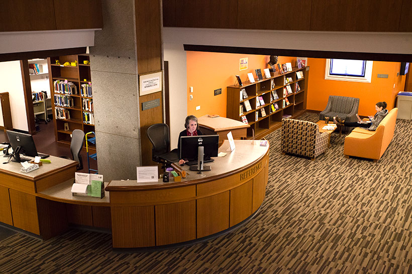 Library staff at the reference desk in Frost Library