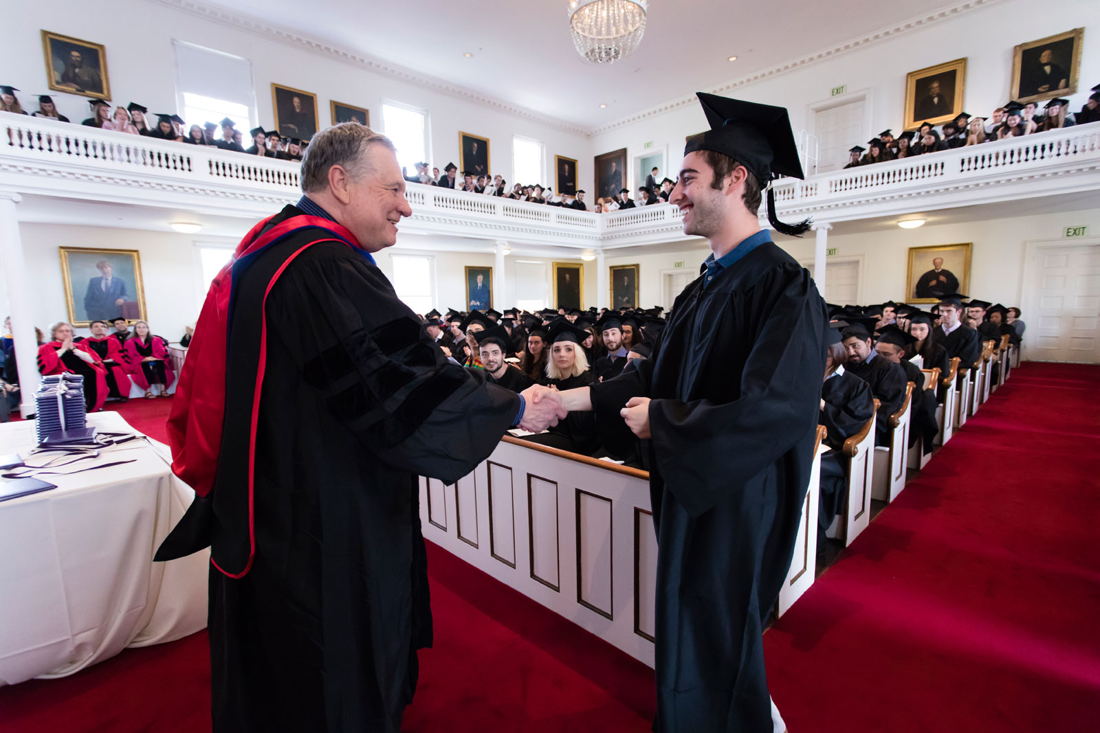 Professor Jack Cheney gives an award to a student