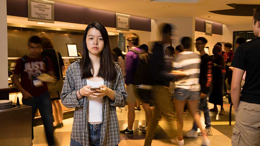 SURF student Jane Kim '20 uses her iPhone to time the lunchtime line at Valentine Dining Hall.