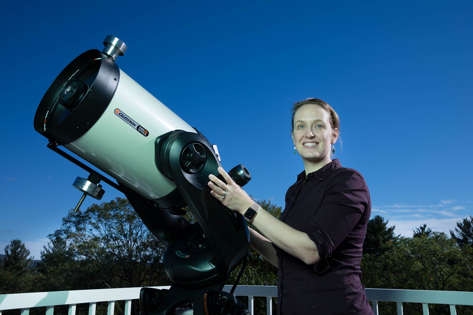 Professor Kate Follette on the roof of the Observatory with a telescope