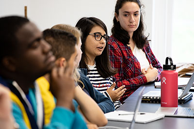 Four college students listen intently during class