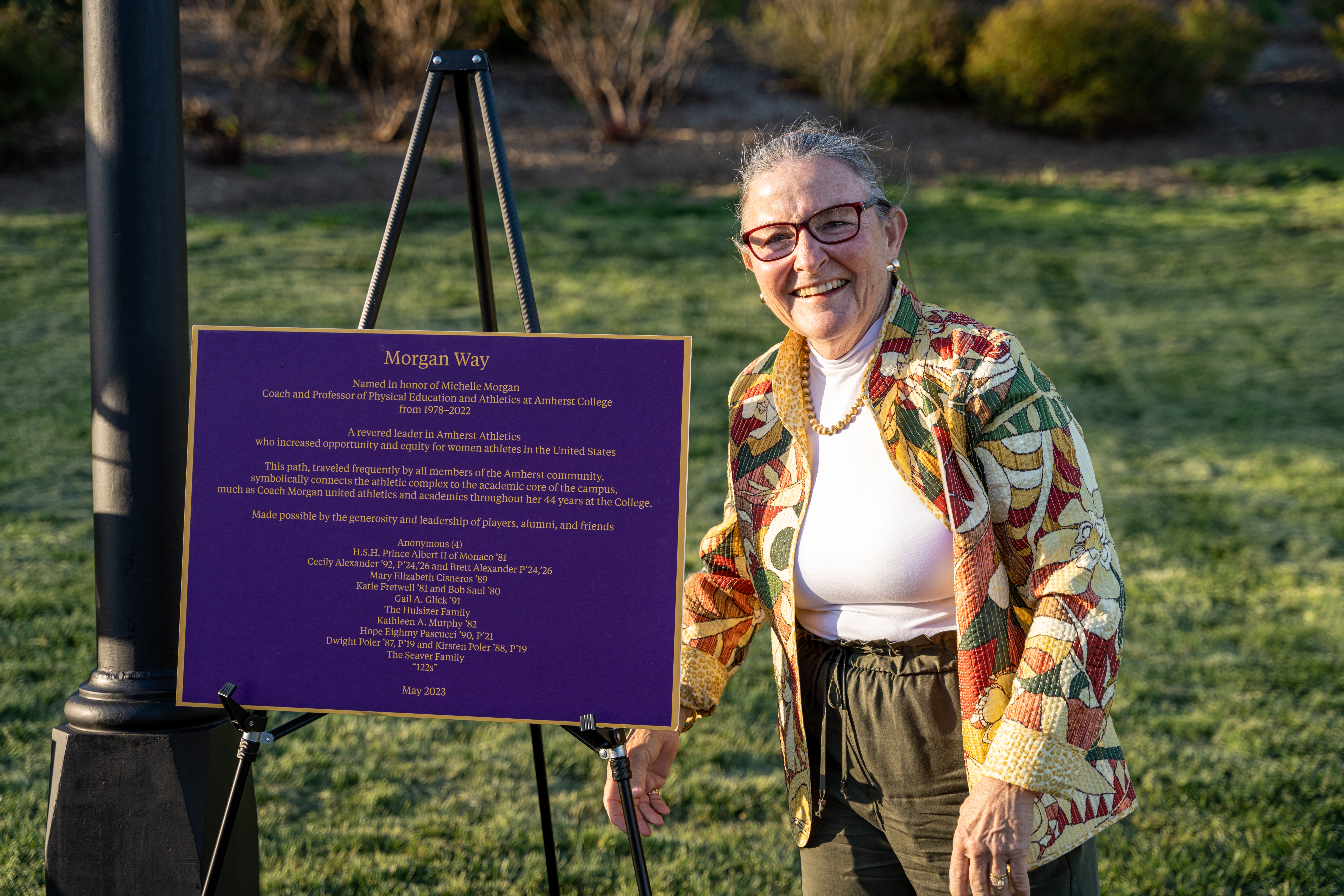 Coach Michelle Morgan smiling with Morgan Way sign