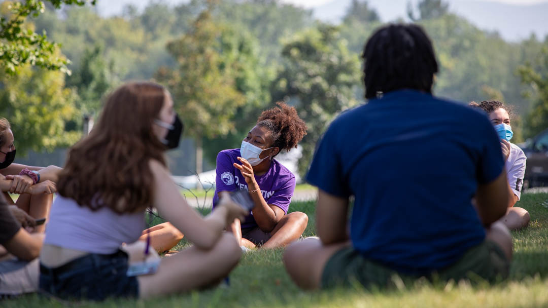 students sitting on the grass during Orientation