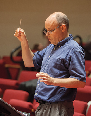 Photo of Eric Sawyer conducting rehearsal in Buckley Recitial Hall