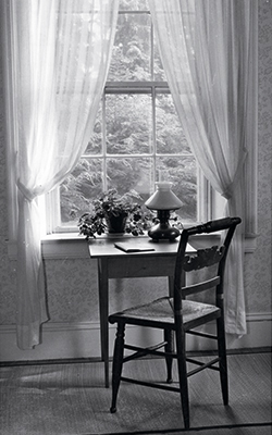 Chair and desk facing window in Dickinson's home