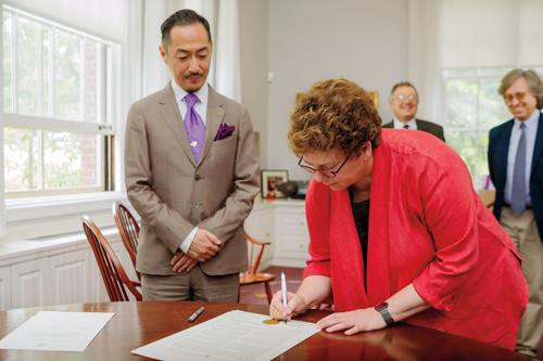 Doshisha President Koji Murata and Amherst President Biddy Martin signing agreement