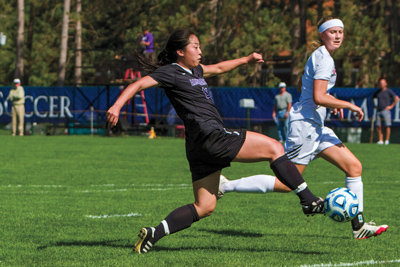 Soccer phenom, Megan Kim ’16, dribbles through Bates defense.
