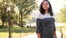 Tracy Jarrett ’11 standing on a path in an urban park