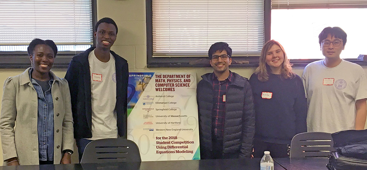 Five college students pose with about a student competition regarding differential equations modeling 