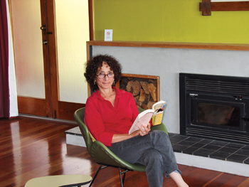 Deborah Gewertz seated, holding her book