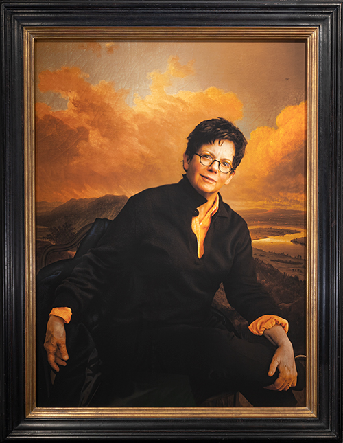 A presidential portrait of Biddy Martin against a dramatic background
