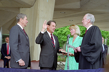 A person getting sworn into office net to Ronald Reagan