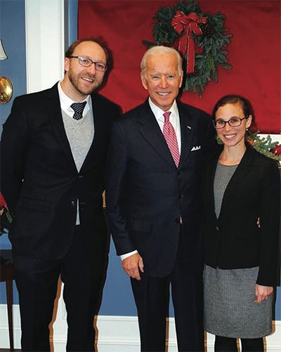 A man and a woman poising with President Biden