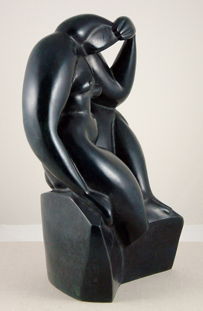 A modern sculpture of a seated woman