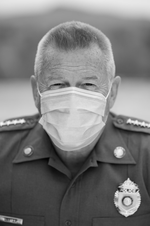 Police chief John Carter wears his uniform and a mask