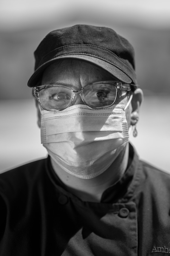 Maria Ortiz wears an Amherst dining services uniform and a mask