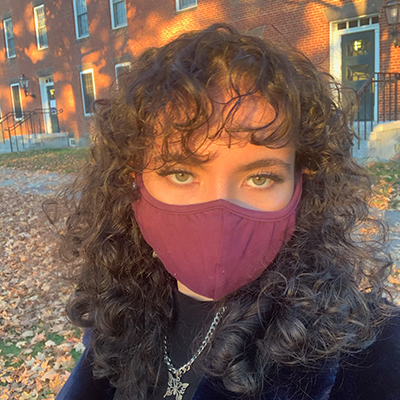 A young woman in a face mask poising for the camera