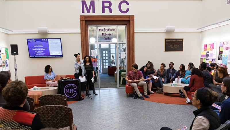 A group of students speaking in the student center under a sign that reads MRC
