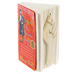 A book with a fist carved into its outer spine