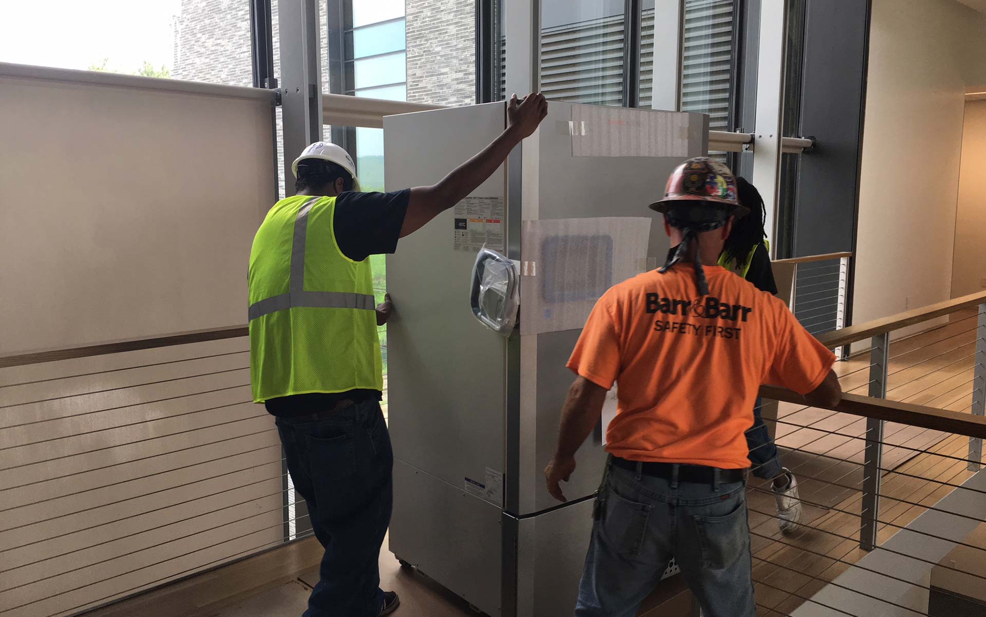 Workmen moving refrigerators into the new Science Center
