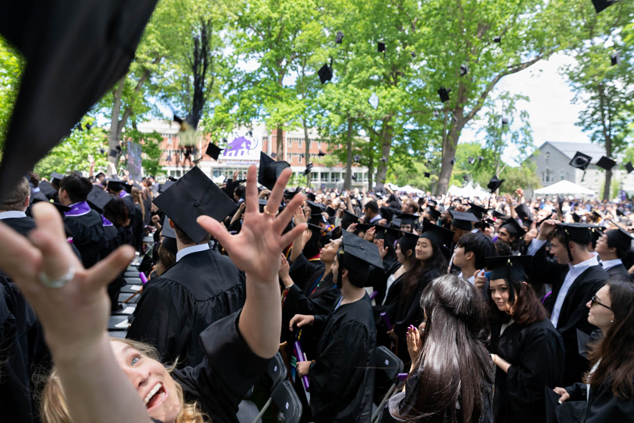 graduates throw their caps into the air
