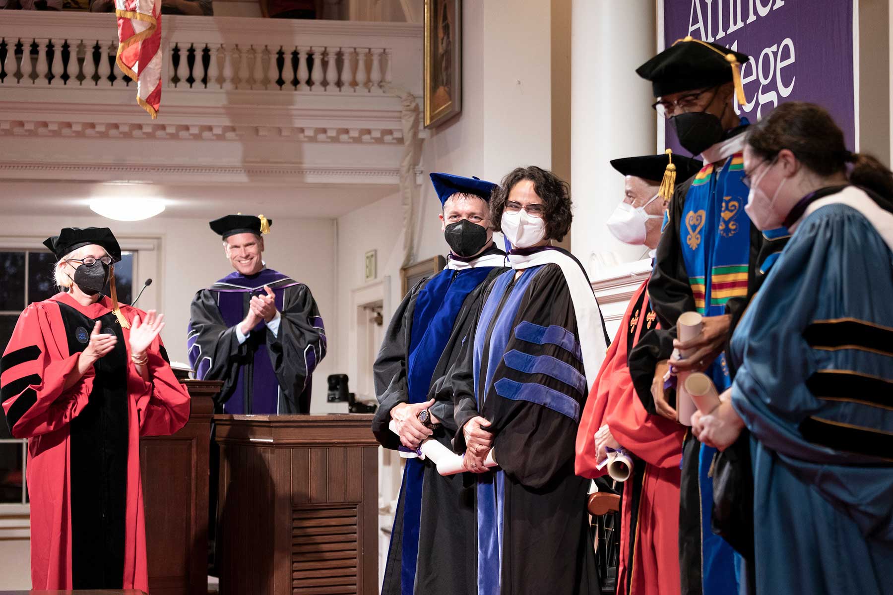 Faculty in regalia receiving honorary degrees at Convocation.