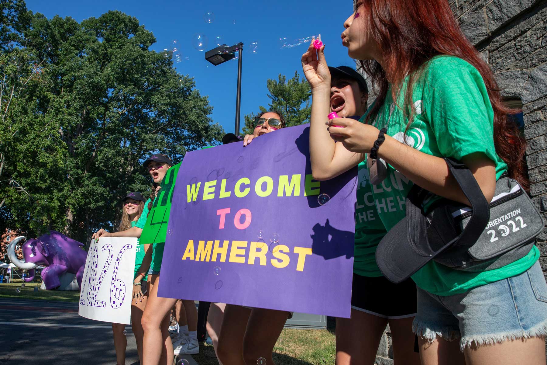 Students hold Welcome to Amherst signs.